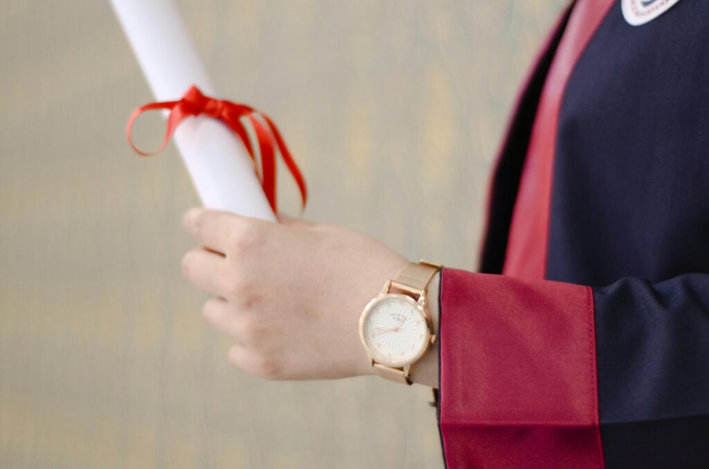 pexels-photo-2293019-2293019 A close-up of a graduate's hand holding a diploma, symbolizing success and achievement.
